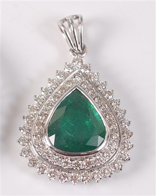 Lot 2148 - A white metal, emerald and diamond pear shaped...