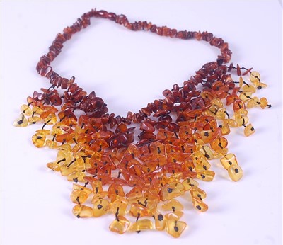 Lot 2127 - A multi-strand amber fringe necklace,...