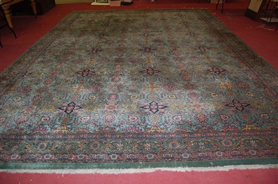 Lot 2496 - A Persian woollen green ground carpet, of good...