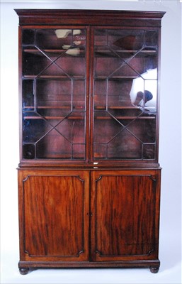 Lot 2545 - A late Georgian mahogany bookcase cabinet, the...