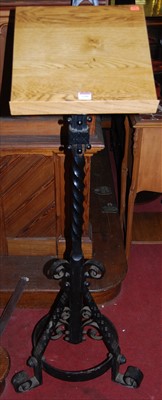 Lot 1101 - A Gothic style black painted wrought iron and...