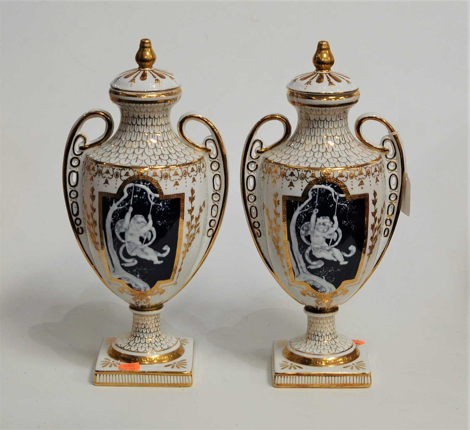 Lot 24 - A pair of modern twin handled vases and covers,...