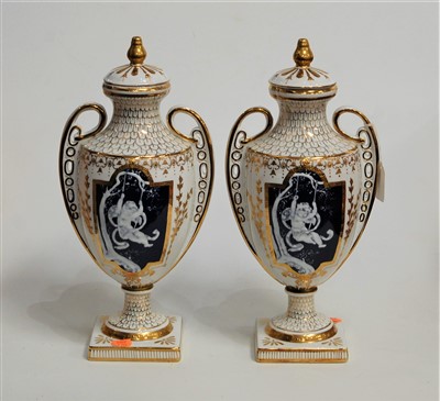 Lot 24 - A pair of modern twin handled vases and covers,...