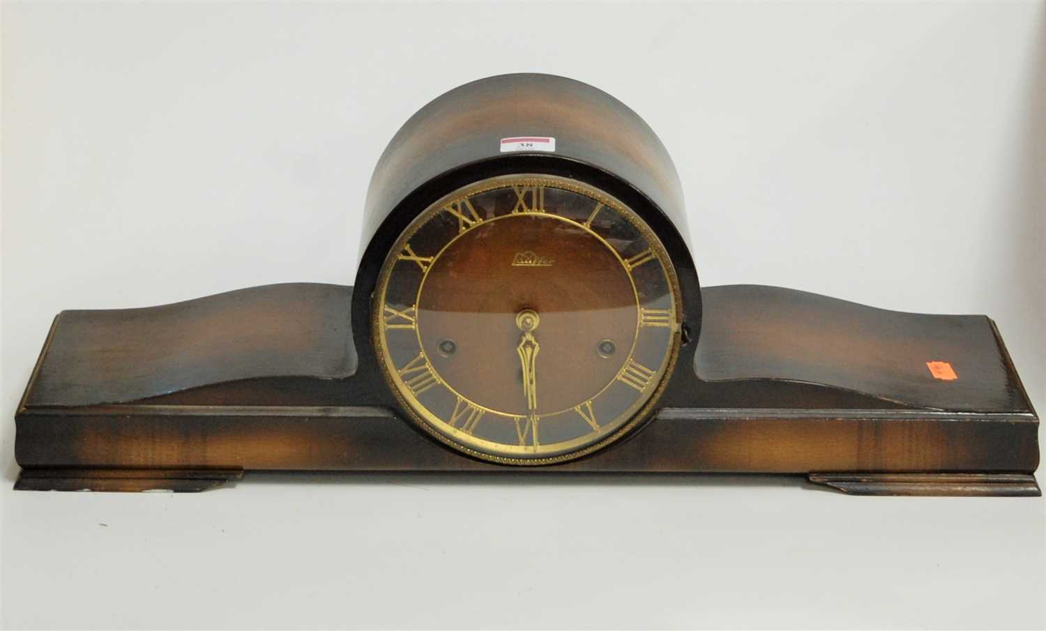 Lot 38 - A 1950s beech cased mantel clock, the brass...