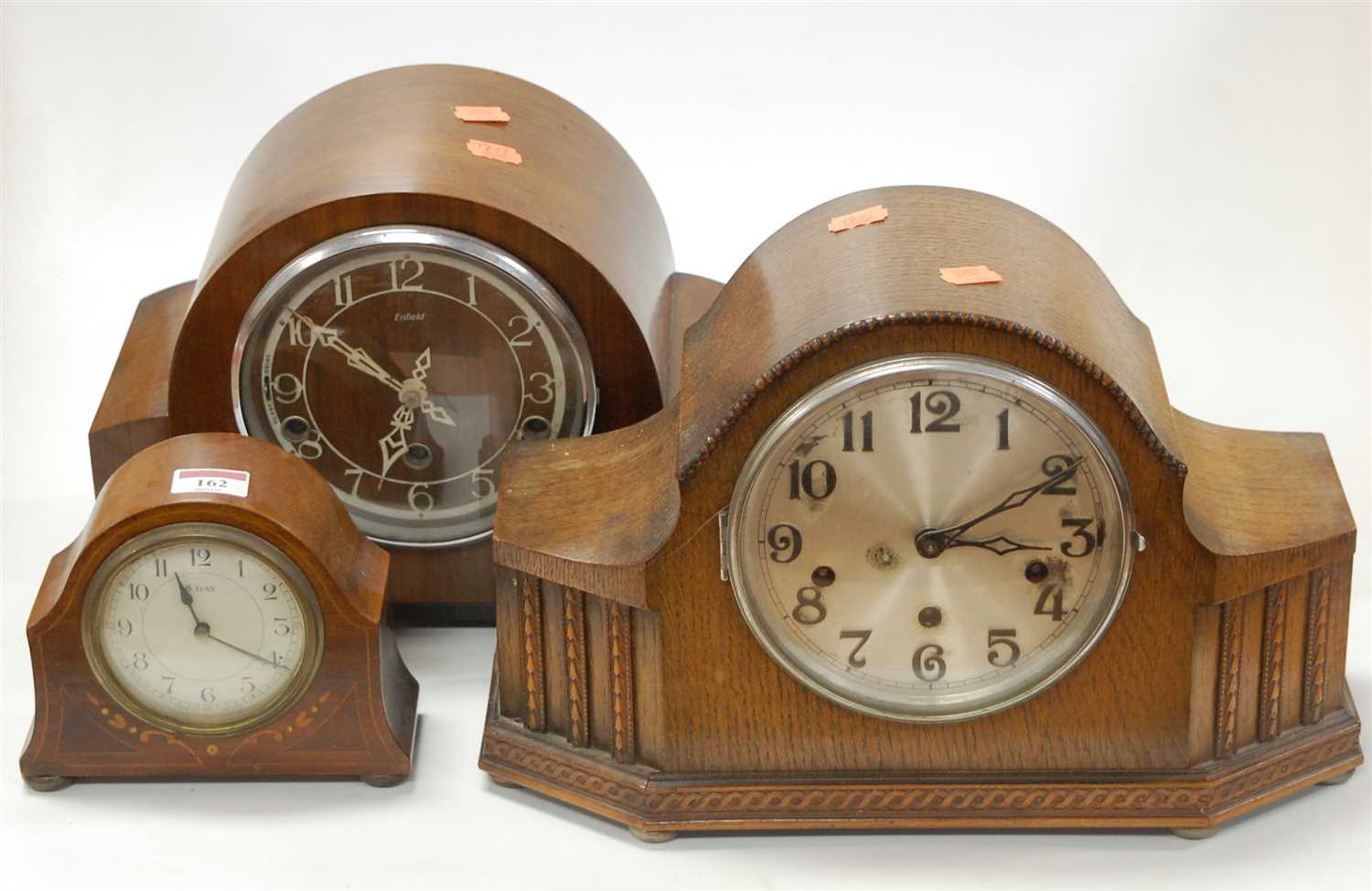 Lot 162 - A 1930s oak mantel clock having a silvered...