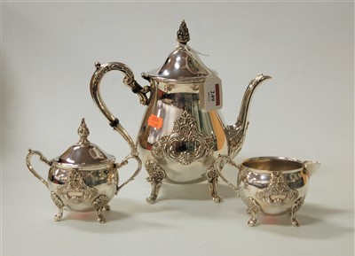 Lot 249 - A modern silver plated three-piece tea set in...