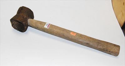 Lot 86 - A cast iron sledgehammer with wooden handle,...