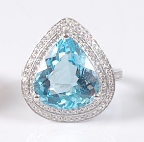 Lot 2179 - A white gold, blue topaz and diamond pear...
