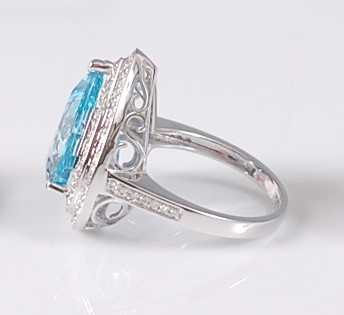 Lot 2179 - A white gold, blue topaz and diamond pear...