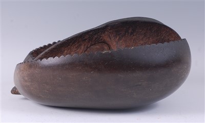 Lot 2254 - A coco de mer nut pod, cut away and carved to...