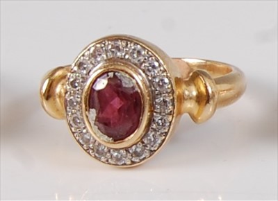 Lot 2134 - A yellow metal, ruby and diamond oval cluster...