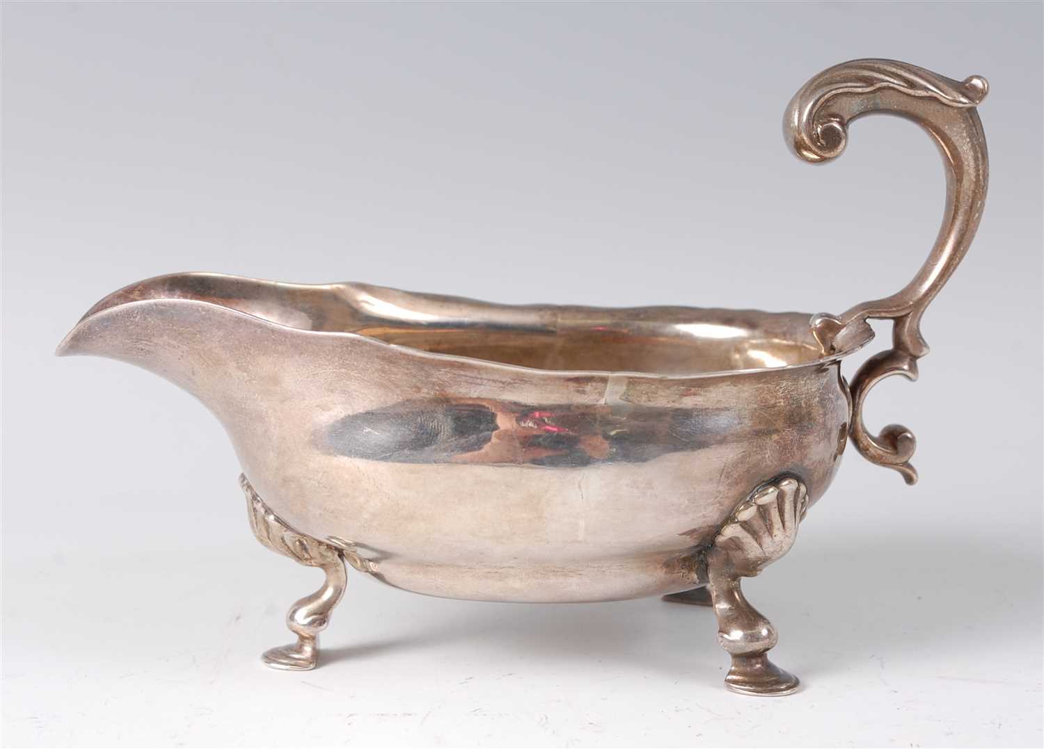 Lot 2107 - A George II silver sauceboat, having acanthus...