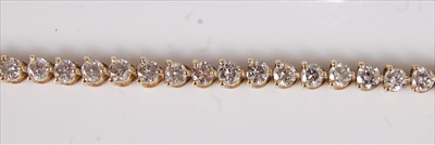 Lot 2207 - An 18ct yellow gold diamond tennis bracelet,...