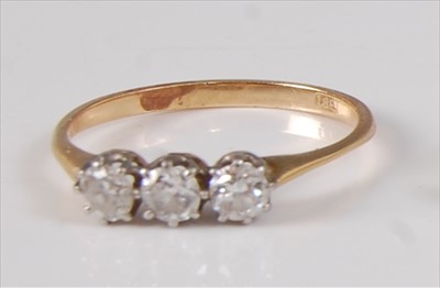 Lot 2182 - A yellow and white metal diamond trilogy ring,...