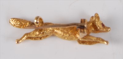 Lot 2214 - A yellow metal running fox brooch, with clip...