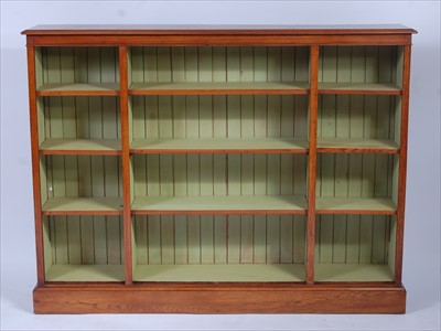 Lot 2577 - A large oak freestanding open bookshelf,...