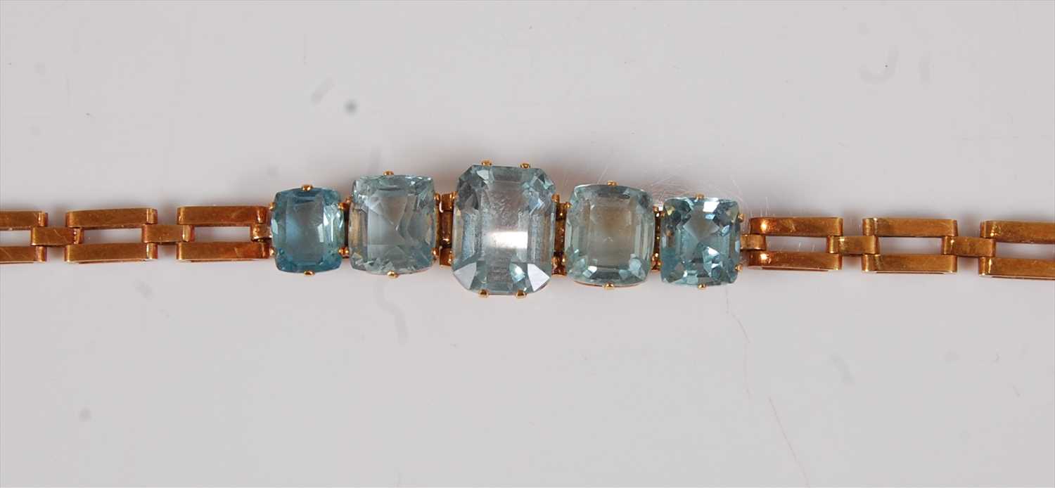 Lot 2159 - A yellow metal aquamarine bracelet, featuring...