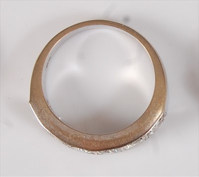Lot 2183 - A white metal diamond half hoop eternity ring,...