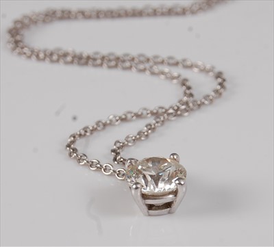 Lot 2228 - A platinum set diamond pendant, the round cut...