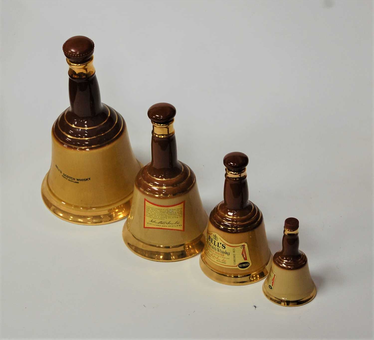 Lot 65 - A Wade Bells Scotch Whisky bell together with...