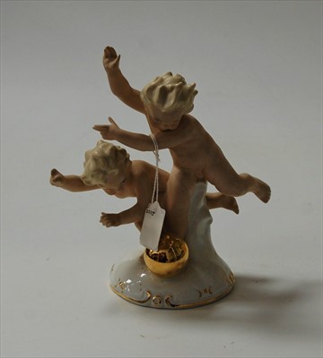 Lot 200 - A continental porcelain figure of two children...