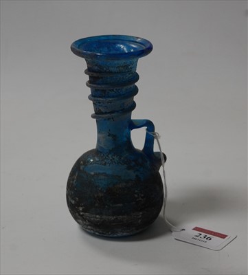 Lot 236 - A Roman? blue glass vase having a flared rim...