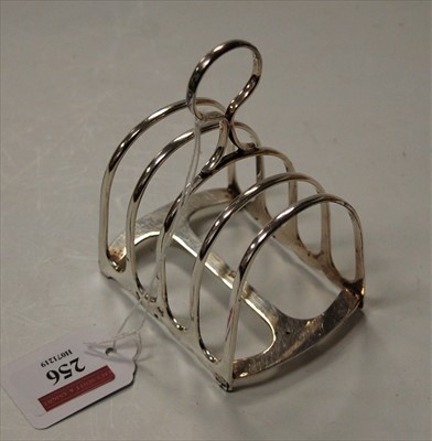 Lot 256 - An Edwardian silver four division toast rack,...