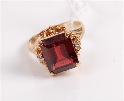 Lot 326 - A yellow metal garnet set dress ring, the...