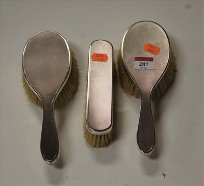 Lot 287 - A set of three 1970s silver backed brushes,...