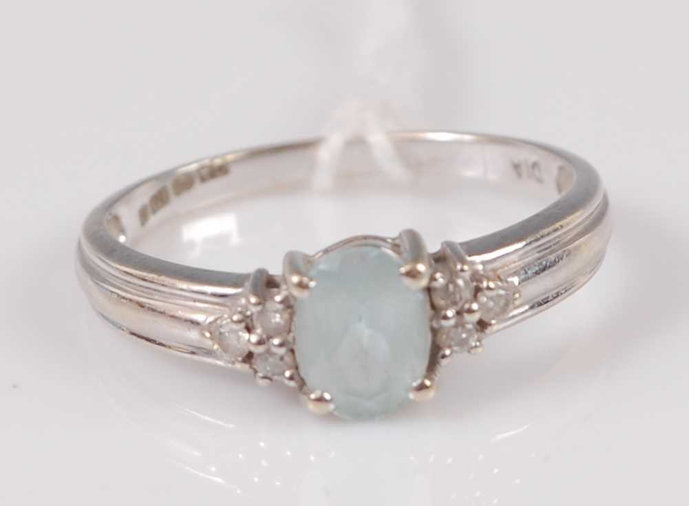 Lot 306 - A modern 9ct white gold blue topaz dress ring...
