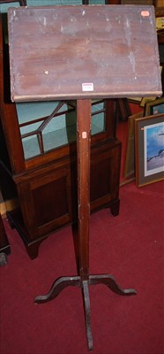 Lot 1100 - A stained pine freestanding lectern, raised on...