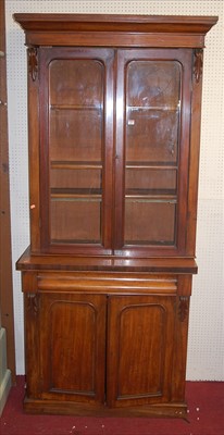 Lot 1106 - A mid-Victorian mahogany bookcase cupboard,...