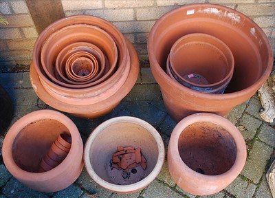 Lot 1124 - A collection of various sized terracotta plant...