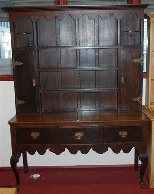 Lot 1136 - An 18th century style oak dresser, the upper...