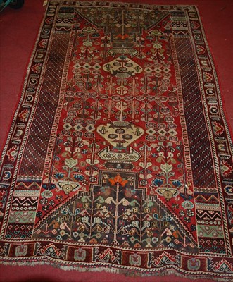 Lot 1146 - A Persian red ground woollen rug, having...