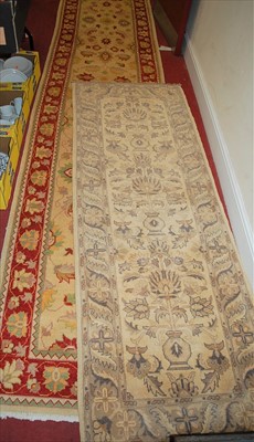 Lot 1155 - A Persian style cream ground woollen long hall...