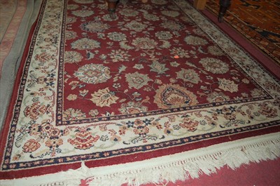 Lot 1157 - A Persian style machine woven red ground rug,...