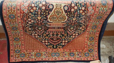 Lot 1162 - A small Persian woollen blue ground prayer rug,...