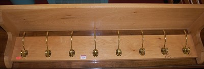 Lot 1186 - A contemporary light oak hanging coat rack...