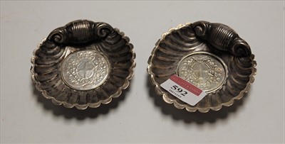 Lot 592 - A pair of white metal scallop shaped dishes...