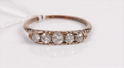 Lot 409 - A 9ct gold diamond five stone ring, the...