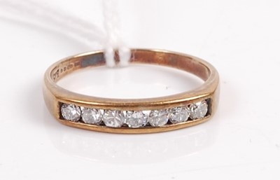 Lot 411 - A 9ct gold diamond half eternity ring, the...