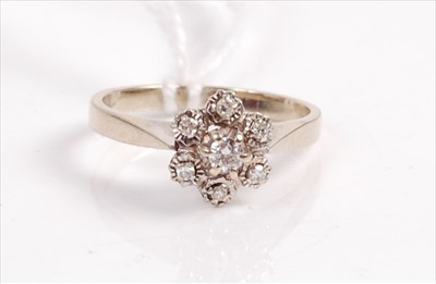 Lot 413 - A white metal diamond flower head cluster ring,...