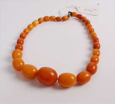 Lot 426 - A beaded faux butterscotch amber necklace,...