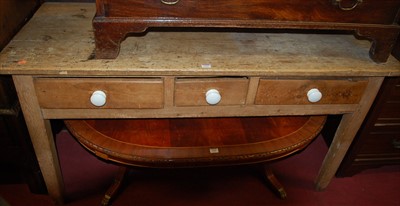 Lot 1204 - A rustic pine three-drawer side table on...