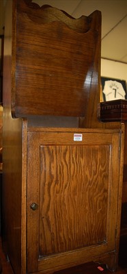 Lot 1221 - A 1930s oak twin division magazine cupboard...