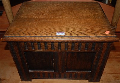 Lot 1228 - A miniature oak hinge top twin panel blanket...