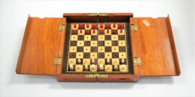 Lot 640 - A circa 1900 mahogany folding travel chess set,...