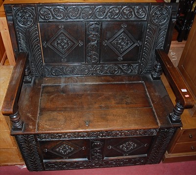 Lot 1268 - An antique joined and relief carved oak twin...