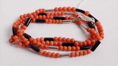 Lot 469 - A beaded coral, black onyx and white metal...